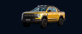 Yellow pickup truck driving on a highway with mountains in the background